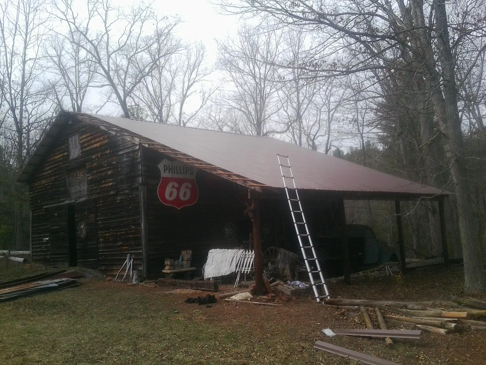 New metal roof on an open sided timber barn with a vintage sign in Manakin Sabot